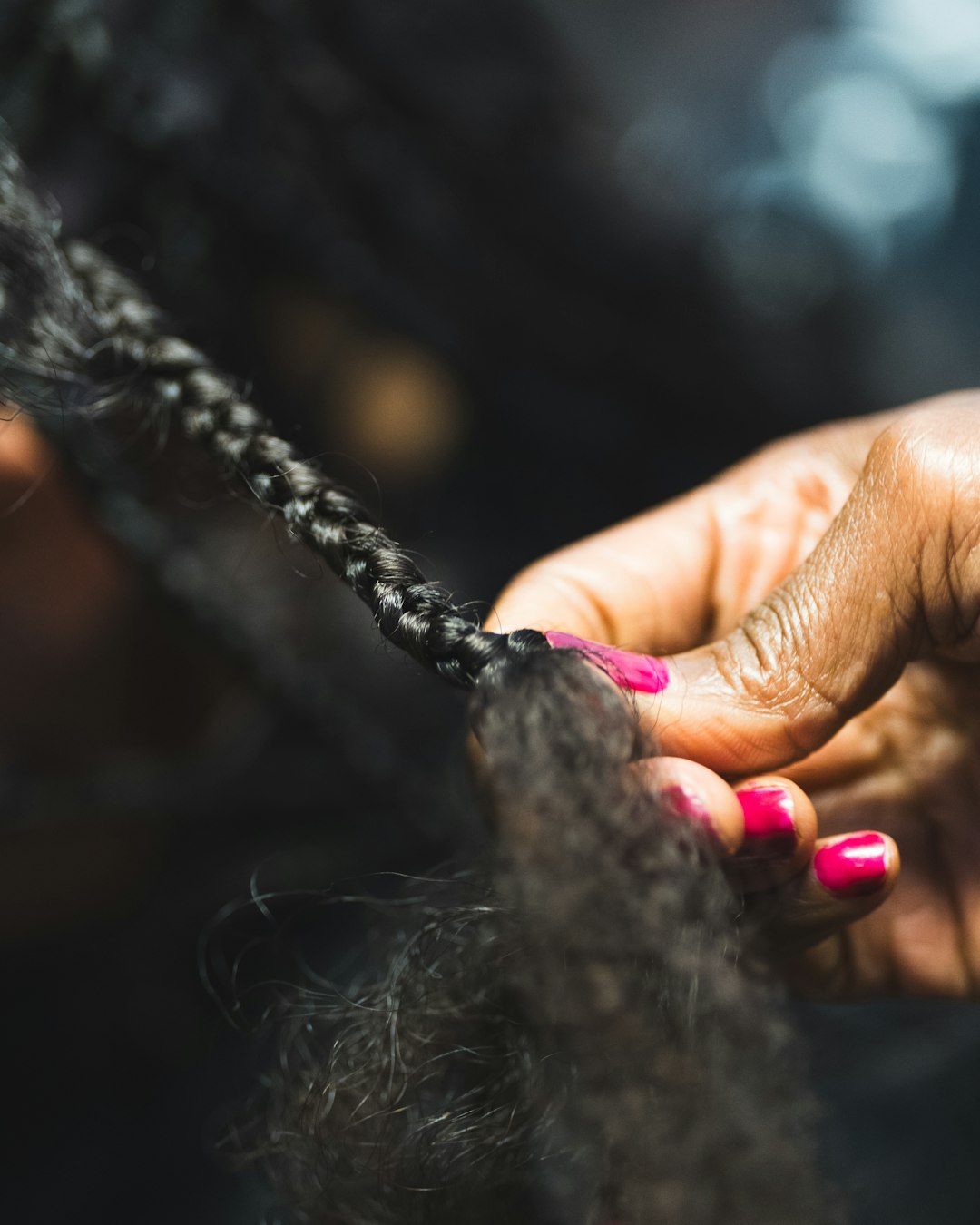close-up-of-hands-braiding-dark-hair-jit2v8rvbau
